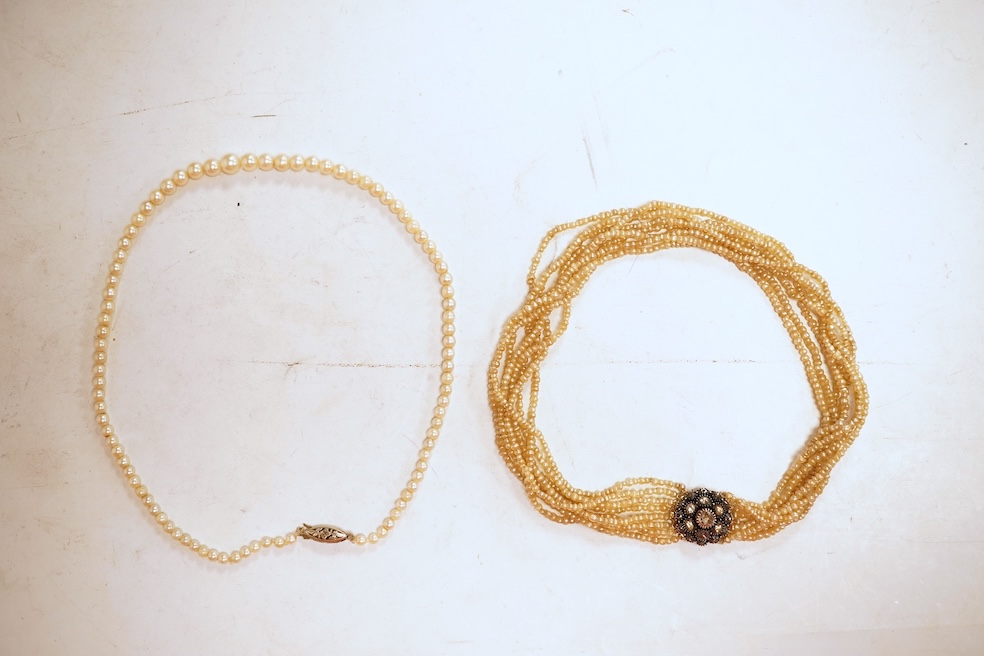 An eight-strand seed pearl choker necklace, with a rose-cut diamond clasp, length 34cm, pearls untested; together with a single strand graduated cultured pearl necklace, length 40cm, clasp stamped 9ct, Condition: good, s